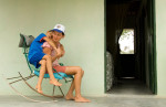 Valdenice de Oliveira sits on the porch of her Habitat home with her seven year-old son Vandeildo.  Before Habitat started building concrete houses here in 2006, most homes were made of dried mud, which not only required constant patching and reshaping but also served as a breeding ground for a type of beetle that poses a serious health threat to humans.© Habitat for Humanity International/Ezra Millstein