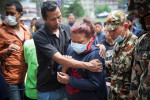 KATHMANDU, NEPAL (4/27/15)-A Nepali woman identifies the body of her dead cousin, after he was removed from a collapsed building, two days after a huge 7.8-magnitude earthquake struck Nepal, and was felt as far as India and Pakistan. © Habitat for Humanity International/Ezra Millstein
