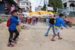 Family members transport the body of a Nepali man, after a recovery team removed him from a collapsed building, two days after a huge 7.8-magnitude earthquake struck Nepal, and was felt as far as India and Pakistan.  © Habitat for Humanity International/Ezra Millstein