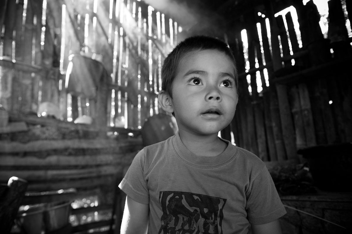 4 year-old Franklin Rojo stands in his family's smokey kitchen.  Habitat for Humanity volunteers helped to build a new kitchen with better air circulation, which will improve thie respiratory health.© Habitat for Humanity International/Ezra Millstein