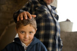 Six year-old Dezika Rac stands next to his father Pater.  Their home is in a Roma community in Hodejov; it is being rehabilitated thanks to a loan from Habitat for Humanity Slovakia.© Habitat for Humanity International/Ezra MIllstein