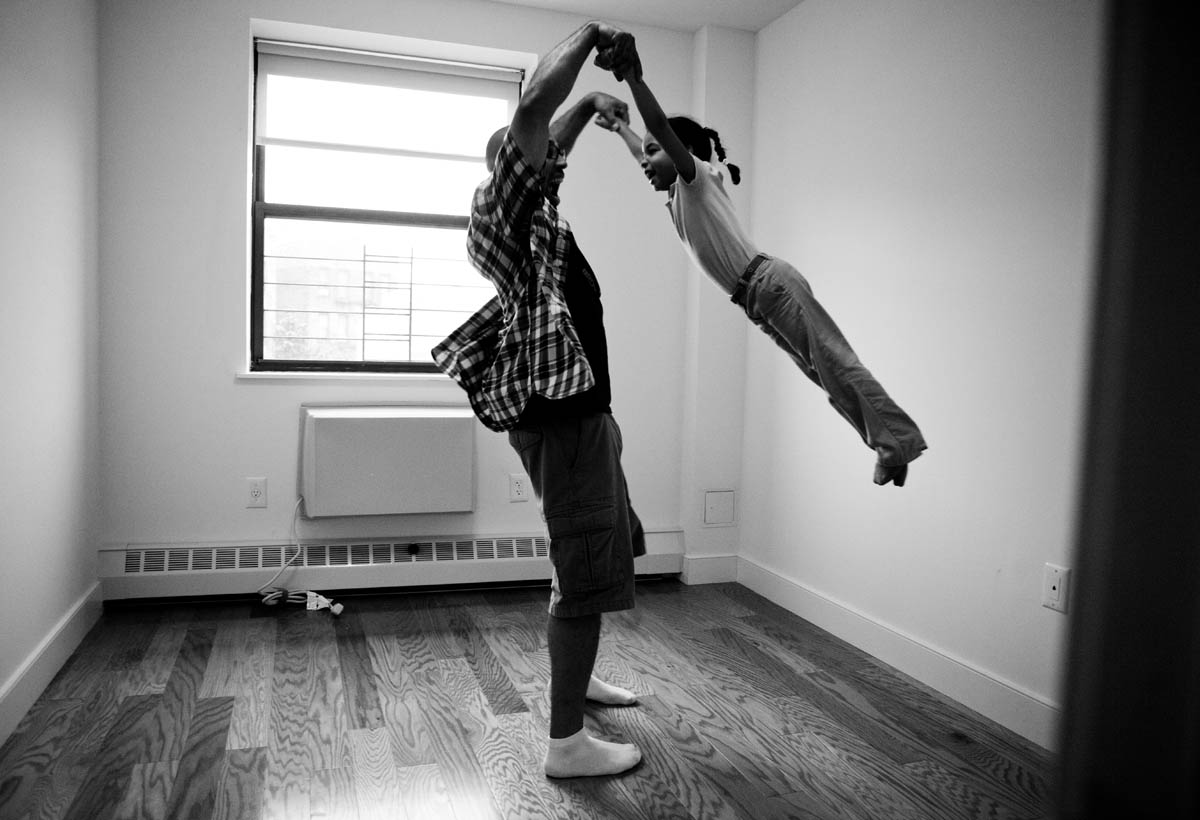 Ricardo Vasquez plays with his daughter Freedom (4) in their family's new condominium at St. John's Residences in Ocean Hill-Brownsville, Brooklyn.  These four-story buildings with 2 and 3-bedroom condos were built on three vacant lots, which had previously been neighborhood eyesores.  Partially funded by Federal NSP2 funds, they were dedicated on September 15, 2012.  © Habitat for Humanity International/Ezra Millstein