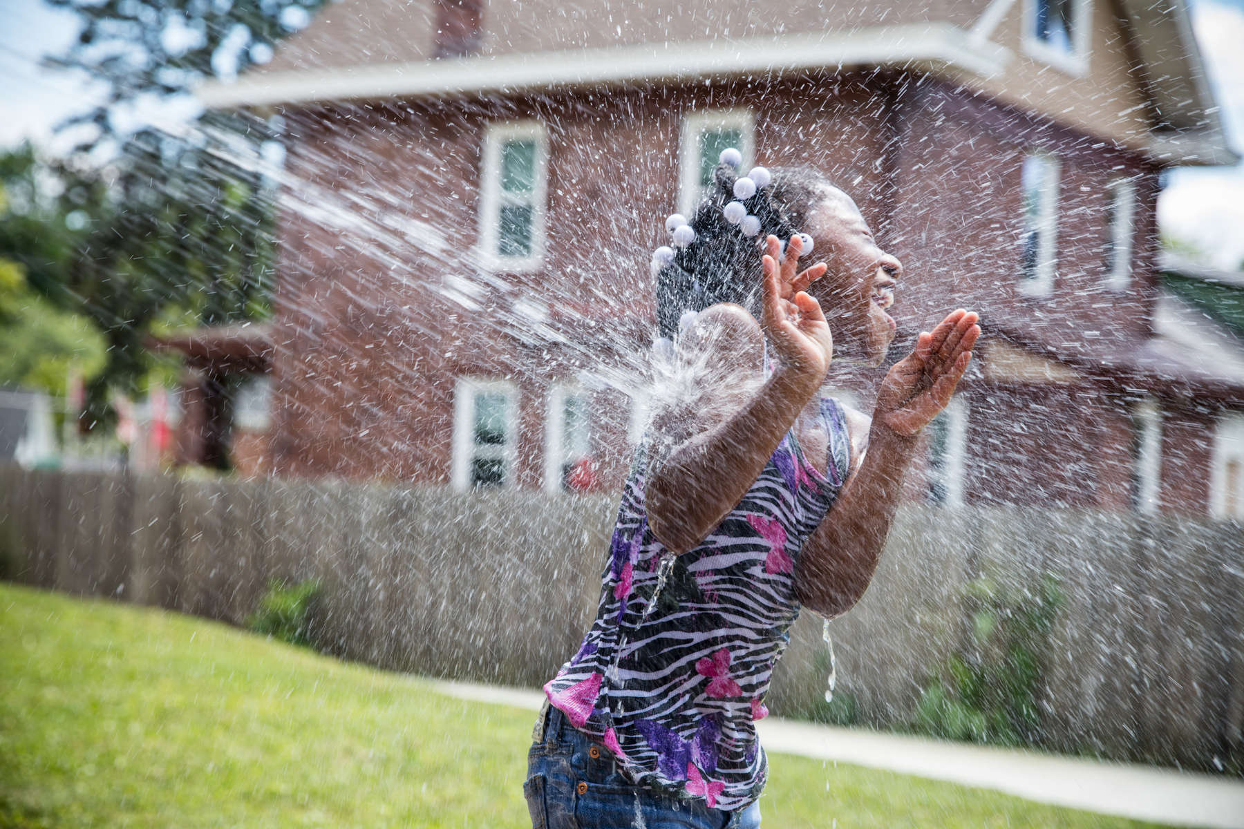 Water fight in the backyard.© Habitat for Humanity International/Ezra Millstein