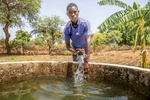 Abdoulfataou Ganda, 18, stands next to a well on his farm. “Most of our friends migrate to seek a better life,” Abdoulfataou explains. He has taken over his father’s farm, which earns him enough to be self-reliant and support his family. Like many youth in his community, he is at risk of migrating in search of opportunity, which means their communities are losing talent and skill to other places. But Abdoulfataou participated in Mercy Corps’ financial literacy training, where he learned about budgeting, saving and how to seek microfinance support for business, which helped solidify is believe that a good life is possible at home. “To me, it’s always better to be at your home, that’s where you can naturally be fine,” he says. “Home is home. And I believe that you can make a business and a good living even here, as long as you have something to do.” Driven by poverty, a lack of opportunity, and cultural expectation, many people in Niger migrate to different areas or countries for months or years at a time to earn income and experience life outside their home community. Migration routes have become increasingly dangerous and costly, putting migrants who don’t know their rights at risk of violence or exploitation. However, migration also has the benefit of enabling people to gain skills they would otherwise not, which they can utilize in their home communities if they return and have access to opportunities. Mercy Corps’ AMIPA program works with returning migrants and those at risk of migrating to provide education about the risks, so people can make informed decisions, while also providing financial inclusion and business support for those who have returned or choose to stay, so that they may access livelihoods in their home communities.  