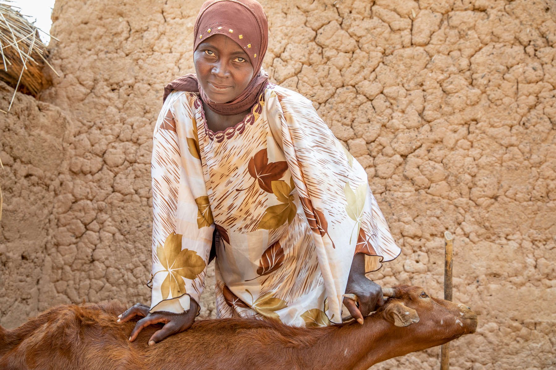 Hadiara, 35, feeds her goats. She and her family live in a small, rural village 90 minutes outside Niamey where families rely heavily on agriculture and nearly everyone lives hand-to-mouth. Food shortages are chronic here, even more so in recent years as the rains have become increasingly less reliable. Like the other women in her community, Hadiara’s days are made of manual labor: cleaning, collecting water and firewood, farming and pounding millet, with the completion of one meal time bleeding into the preparation for the next. “A woman’s life conditions are a question of a lot of struggling to have food and improve our life,” she says. “We work very hard with poor results, and our life is very difficult.”Between 2014 and 2016, Mercy Corps’ ECOUT program was implemented here, providing Hadiara’s family with seeds; cash-for-work to restore farmland; goats; and training on agriculture, nutrition and hygiene. While conditions remain harsh and hunger is still a daily struggle, the family is still seeing some of the benefits from that program: the goat allowed Hadiara to feed her newborn baby when she couldn’t produce breastmilk, and today the animals are healthy — and pregnant, which will provide her with an emergency source of income. “I am taking care of them myself,” Hadiara says of her goats. “They are very precious to me.” 