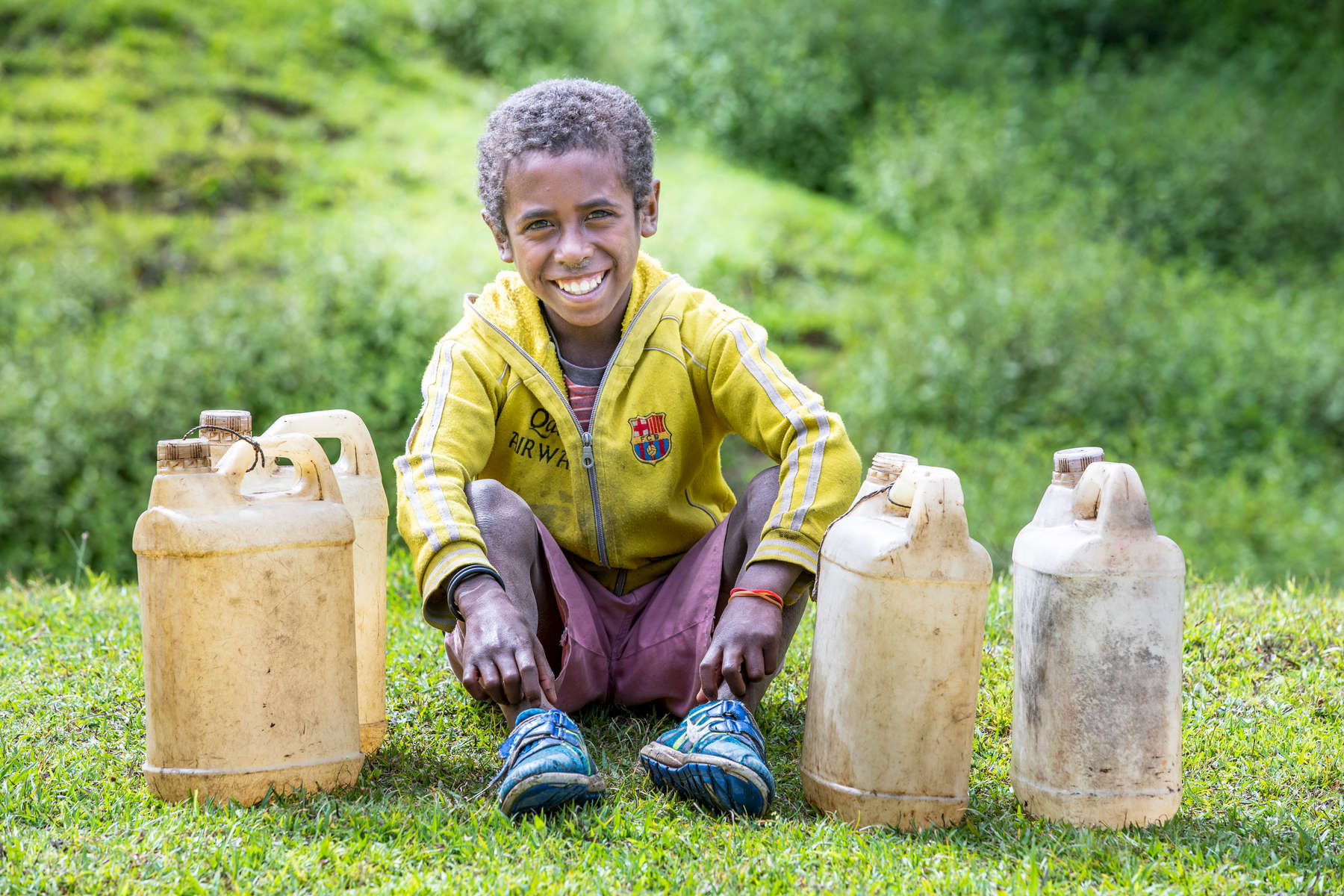 Moises Lopes, 10, rests after collecting water in the central highlands of Timor-Leste.  His village has benefitted from Mercy Corps programs. Americo Pereira, 45, is a community leader from Mulo. He says that Mercy Corps M-RED program has benefitted the village tremendously. “I’m really thankful and happy for all the things that the Mercy Corps M-RED program has done for us. Before, we didn't have any knowledge of farming techniques, but because of the Mercy Corps intervention, now we understand and know how to use techniques to make sure that we have a good plantation and a good harvest.”Farming in Timor-Leste depends on the dry and rainy seasons. Because of climate change, the dry seasons are longer and the rains are harder to predict. That leaves farmers with less to feed their families.Hunger is a serious problem in Timor-Leste, where most families in the rural mountains depend on farming to survive. Mercy Corps is helping farmers manage their own farmers groups, where local communities pull together rather than work alone.