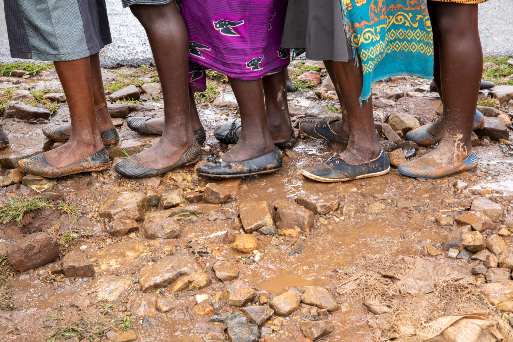 Women wait in line for food at a distribution point called Skyline, on a ridge surrounded by mudslides.