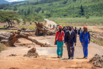 Utility workers walk across the remains of a bridge over the Nyahodi river, which burst its banks and washed away an entire market full of stalls, vendors and customers. It is estimated that 14 bridges around Chimanimani were destroyed, paralyzing transportation and making aid delivery slow and treacherous.