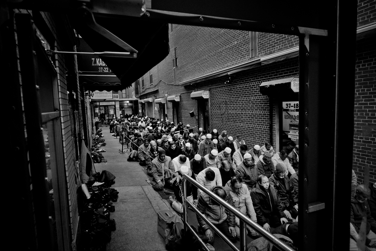 12,11,2015 NY Neighborhood profiles series.  Jackson Heights Queens. Friday prayer at Darul Hidayah Mosque in Little Bangladesh section. Payers spilled over to alley outside the mosque on 73 rd Street. © 2015 Yunghi Kim/Contact Press Images.
