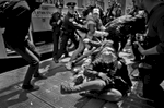 At the May Day Protest, NYC 2012. Undercover and uniformed NYPD scrambles to nab a Black Bloc protester, as others try to rescue her from NYPD's grip. ©2017 Yunghi Kim/ Contact Press Images
