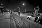 Busy West Side Highway, a woman gets out of her car and show support with protesters by gesturing {quote}hand up, dont shoot.{quote}  Protests erupted nationally for days when a grand jury declined to indict NYPD Police Officer Daniel Pantaleo who used chokehold in the death of Eric Garner in July 2014. Dec 2014. ©2017 Yunghi Kim/ Contact Press Images