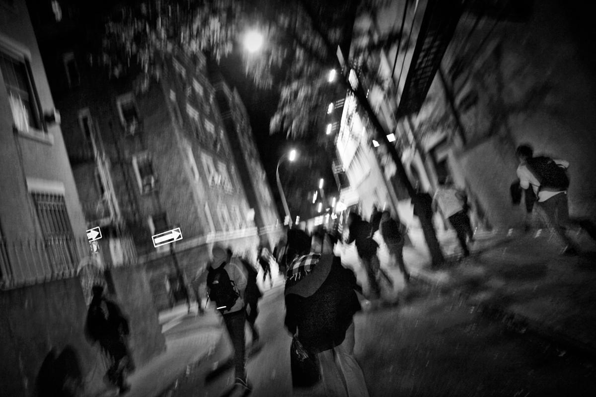 To show solidarity with injured protester Scott Olsen in Oakland CA and to protest police brutality, OWS protesters defiantly march through streets of NYC in a game of cat and mouse with the NYPD. To avoid check points and getting roped in, protesters scramble to out run the cops in smaller side sweets of West Village. Oct 26, 2011. ©2017 Yunghi Kim/ Contact Press Images