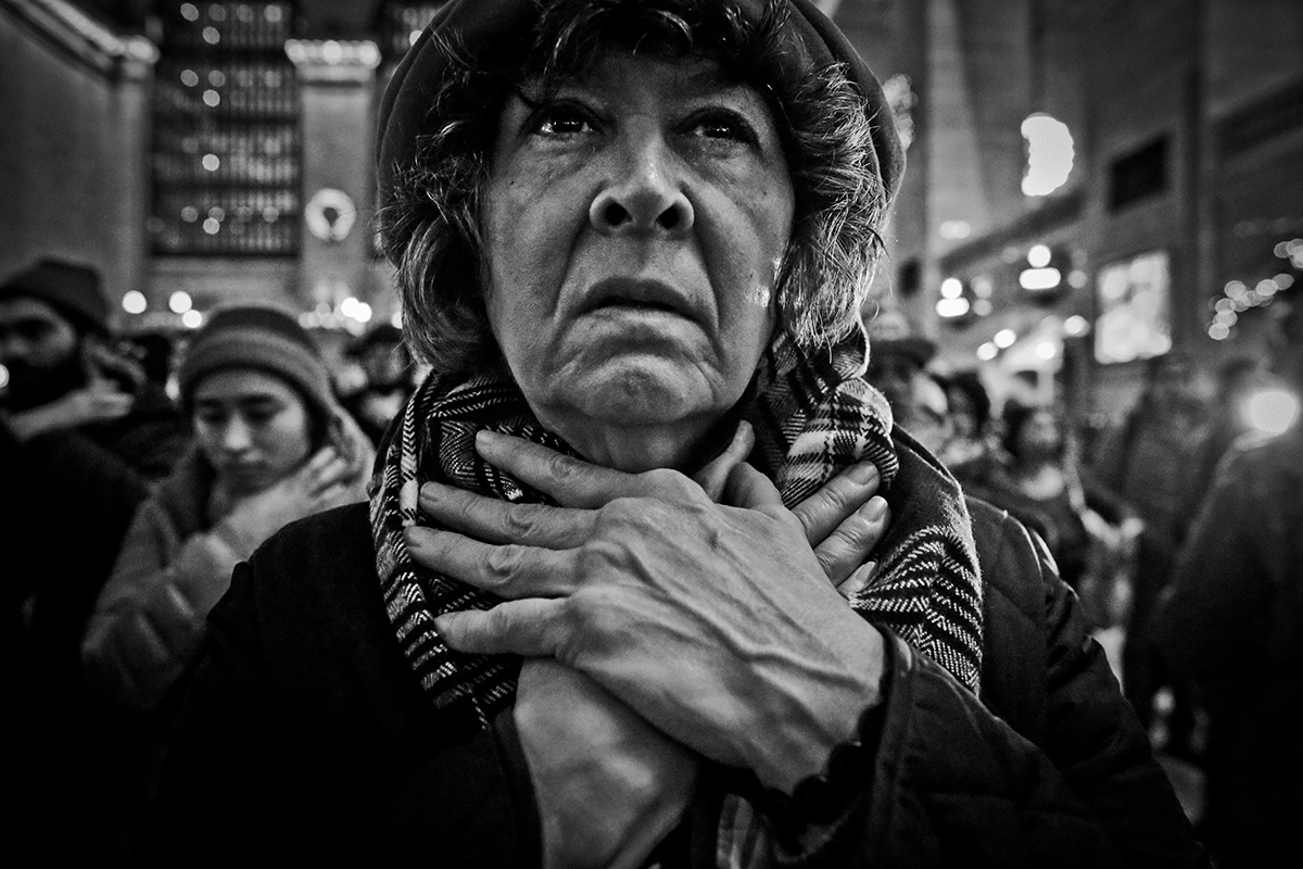 A woman gestures choke Hold during a protest at the NYC's Grand Central Station. Eric Garner, who had asthma when NYPD placed him in what appears to be a chokehold. Garner, 43, can be heard gasping, {quote}I can't breathe!{quote}