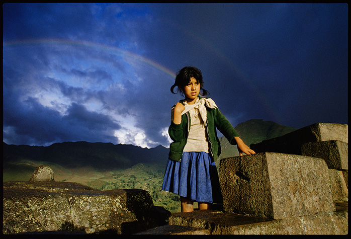 She was walking on the road outside of Cuzco, Peru.And then there was a rainbow.