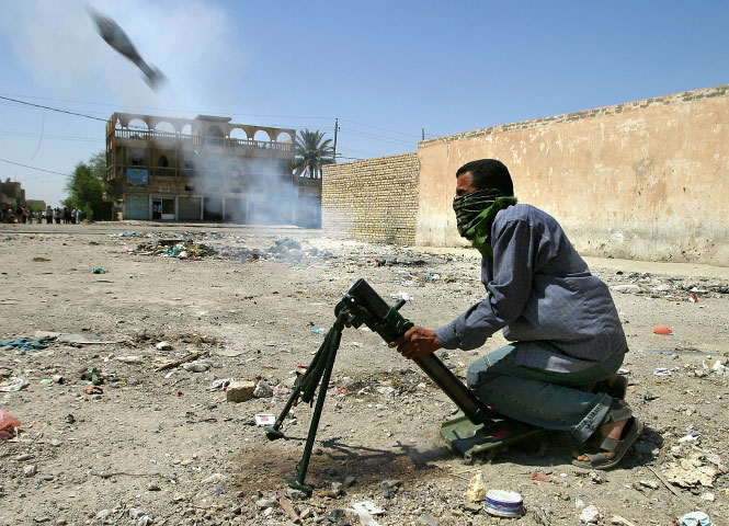 An Mehdi militiaman loyal to the radical Shiite cleric Muqtada al-Sadr, fires a mortar round at a U.S. army position in Sadr City.
