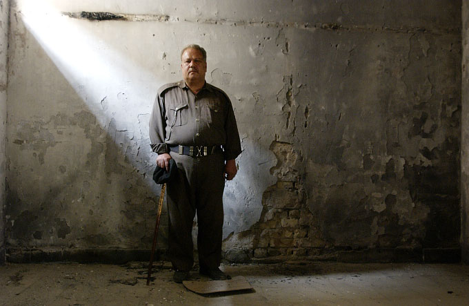 Police Comander Muhammad Shaqeer Abdul Razzak, stands in the looted armory of his police station in the Adhamiya neighborhood in Baghdad. Razzak was wounded in the chaos after the American invasion,  and his weapon was confiscated by the Americans, but he returned to keep watch on what was left of his station until it could be rehabilitated.