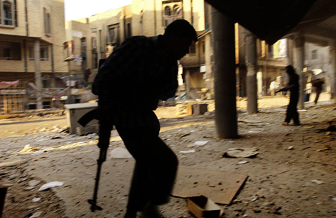 Members of the Mehdi Militia run for cover during a gunfight  with Iraqi police during the three-week siege of Najaf.