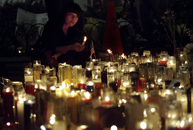 A woman weeps at a cadlelight vigil at Union Square.