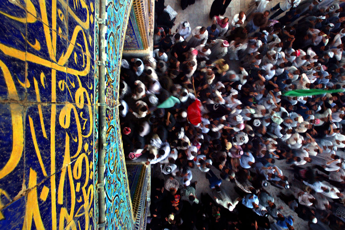 Shiite Muslims exit the Al Hussein Shine as they gather in Kerbala, Iraq on April 22, 2003, to commemorate the life and death of Al Hussein.  Hussein, the grandson of the prophet Mohammed, is a symbol of the struggle against repression for the Shiites.   This year marks the first time since Saddam Hussein took office that the Shiites Muslims of Iraq have come together for the event without the fear repression from the now fallen regime.