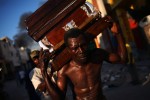 Men carry a coffin through the streets of Port-au-Prince, Haiti on Monday, January 18, 2010 a week after the country was struck by a magnitude 7.0 earthquake, killing thousands.