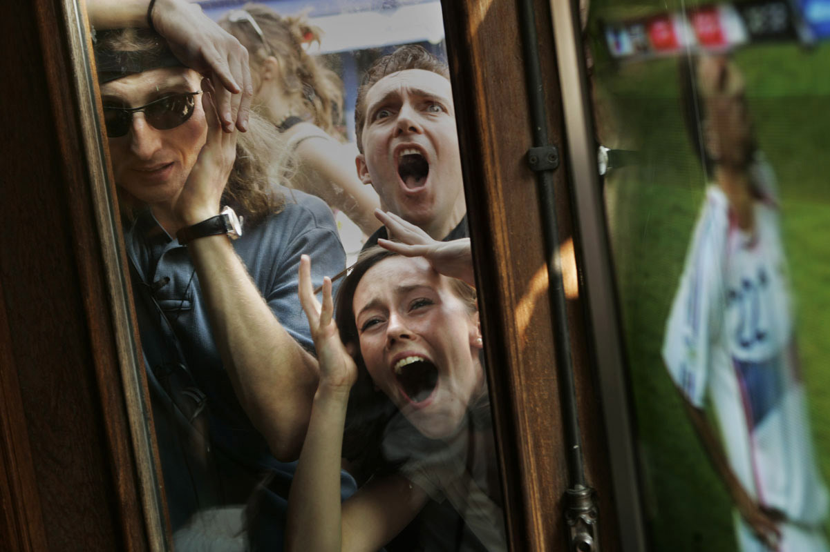 Fans of the French National soccer team react as they watch from outside a French bistro in Soho after a missed goal opportunity during the World Cup final against Italy. Their team would go on to lose the game.