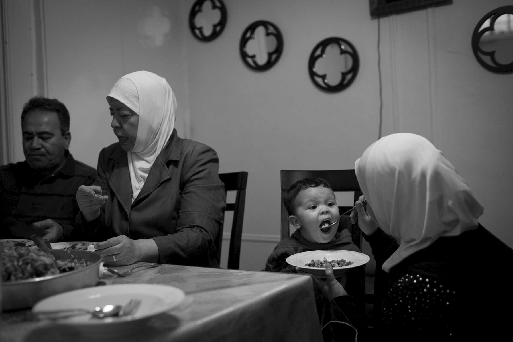 Eman feeds her son, Hassan, a traditional Syrian dish of Maqlooba during dinner in their Brooklyn apartment. Michael Appleton/Mayoral Photography Office