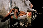 A worker in a back alley of a open market in Salvador.
