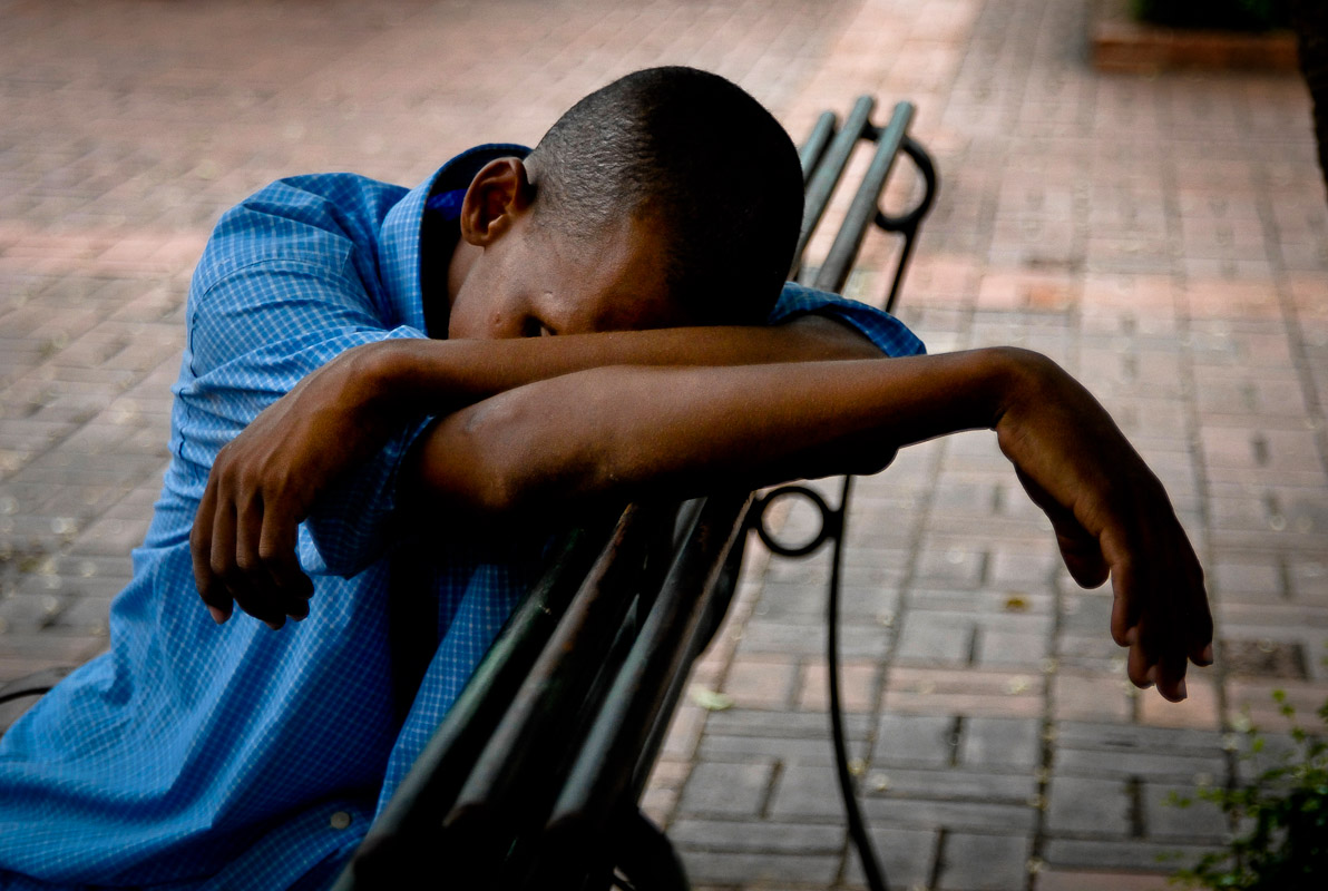 Man sleeping on a park bench in Santo Domingo