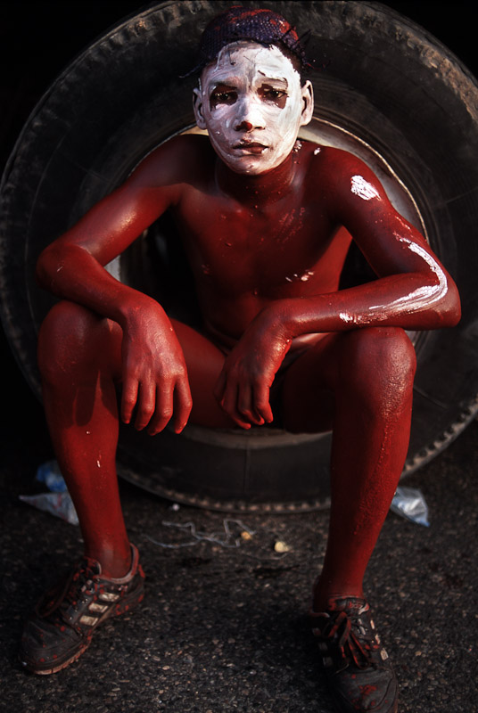 A boy covered in oil and paint for carnaval in Santo Domingo, Dominican Republic