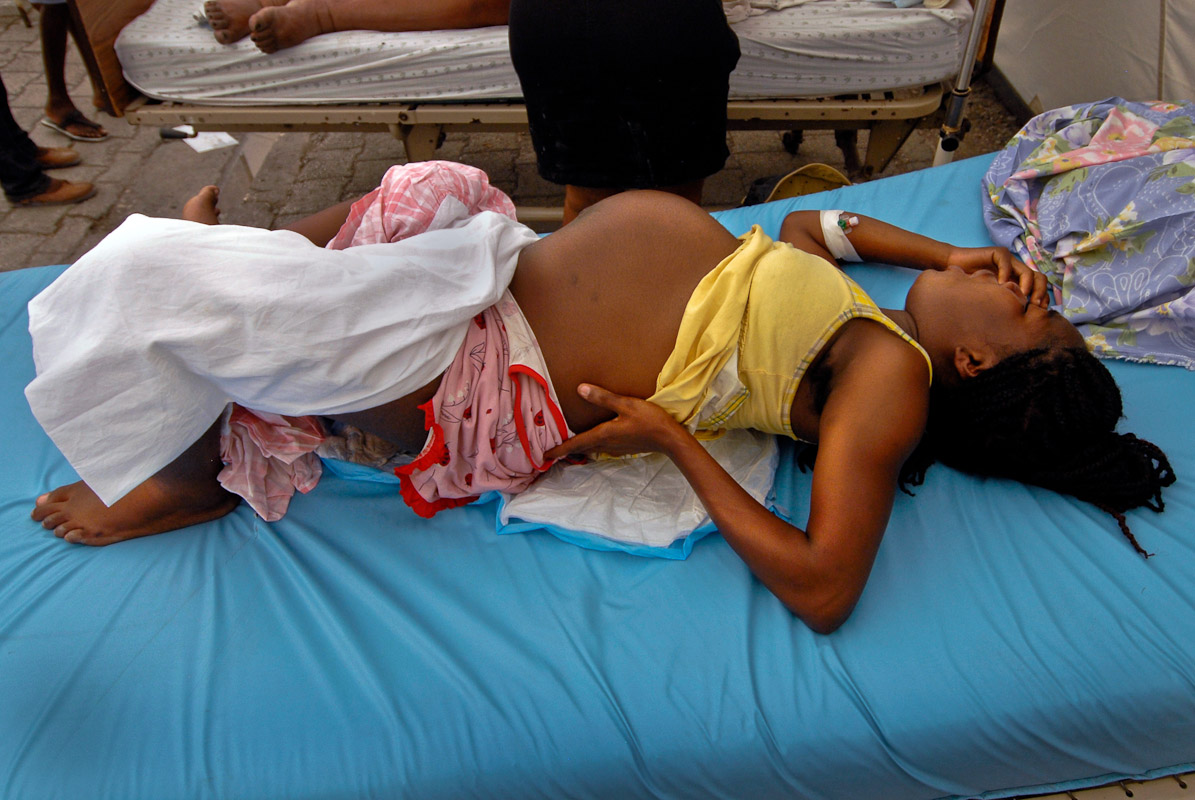 A woman in labor at a maternity tent for victims.