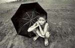 A boy sitting by the bank of the Tapajos River in the Amazon.Boim, Brazil