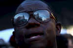 NAT *** Charleston, SC -- 06/20/2015 - Emanuel AME Church is reflected in the glasses of Michael Weeks of North Charleston as he sings outside on Saturday evening. (Travis Dove for The New York Times)