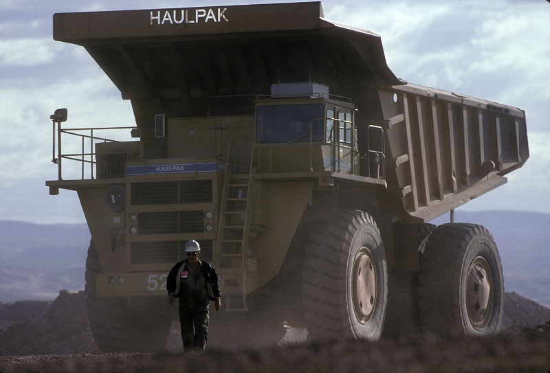 Shot on assignment for NATIONAL GEOGRAPHIC Magazine. A truck driver at the end of his shift at the Neumont Gold's Carlin mine Elko, NV walks away from the mammoth diesel-electric ore truck that  is big enough to carry six full size pick-up trucks in its bed.