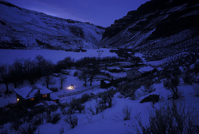 Shot on assignment for NATIONAL GEOGRAPHIC Magazine. Winter evening chores by lantern light at the Stowell family homestead Ranch in the Bruneau River Canyon near Jarbridge, Nevada.