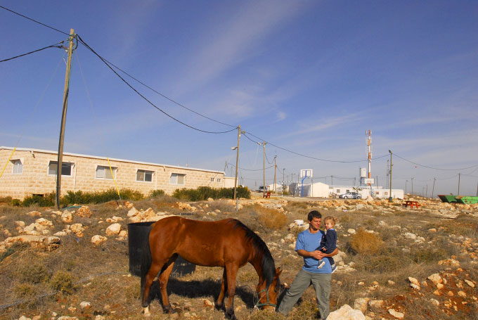 Israeli settler with his daughter and horse in Migron, a newly establised Israeli settlement housing 90 Jewish settlers.