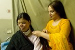 Kanwal Qayyan (left), 25 years old, sits on her hospital bed, while her cousin, Mehnaz Humaoon (right) braids her hair at the Family Health Hospital in Islamabad, Pakistan on November 19, 2008.   Kanwal is one of the 327 female burn victims presently accounted for in Pakistan, most are between the ages of 14 -25. The face and genitalia are the areas most generally targeted, those guaranteeing complete disfiguration.  Motives vary,  but are most frequently obsession, jealousy, suspected infidelity, husband wanting to re-marry, sexual non-cooperation. Kanwal has had 10 surgeries thus far and has many more to go.  She was on her way to her first day of work as an air- hostess when a man she does not know threw acid on her.  She suspects that her husband was involved, but this has not been proven legally.  Kanwal lives in Karachi with her two children.    