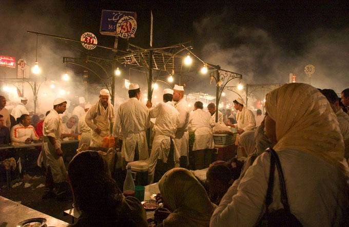 Local Moroccans and tourists gather around the famous food stalls in Marrakesh,Morocco.