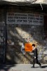 Young ultra orthodox jewish boy walking under an unwelcoming sign in Mea Sharim, a very conservative jewish neighborhood in Jerusalem.  