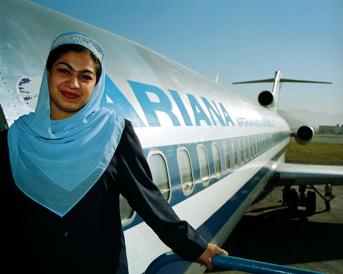Parwana Ghezel, a 27 year old Ariana Afghan Airlines flight attendant, stands in the doorway of an ex-American Airlines 727 airplane at Kabul Airport in Kabul, Afghanistan 
