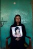 Saira Liaquat, 22yrs, burn victim and survivor, holding an old photograph of herself before she was burned with acid by her husband.  Photographed at Saira's parents' home in Lahore, Pakistan on February 7, 2009.  Saira is presently working as beautician at the Depilex beauty salon in Lahore, Pakistan.  There are presently over 300 cases of burn victims registered in Pakistan.  Most victims are between the ages of 14 - 25 years old.  Motives vary,  but are most frequently obsession, jealousy, suspected infidelity, husband wanting to re-marry, sexual non-cooperation.    The face and genitalia are the areas most generally targeted, those guaranteeing complete disfiguration.