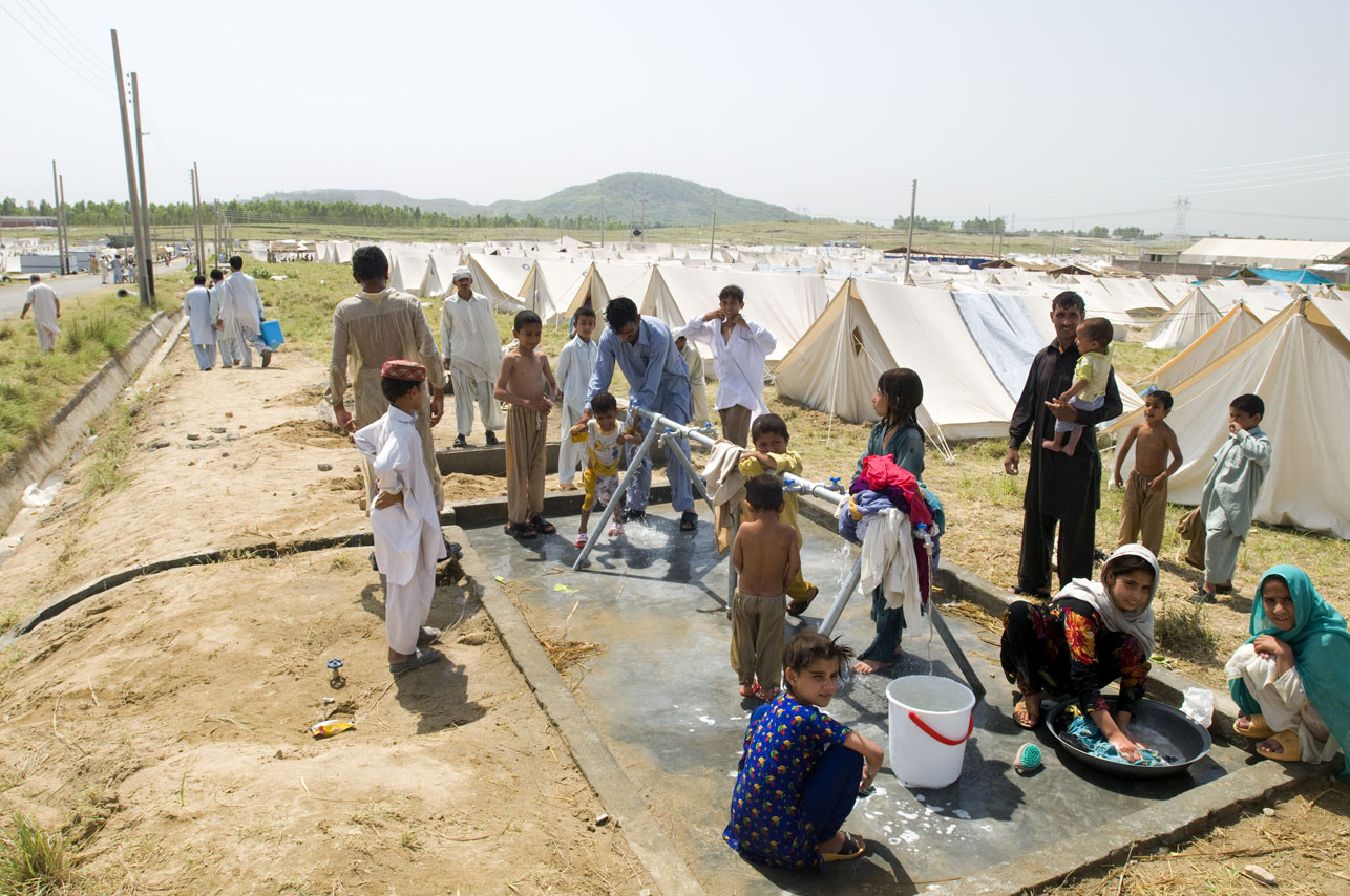 Refugees from Swat bathing and washing their clothes and one of the water springs set up at the Swabi IDP camp in Swabi, Pakistan on May 20, 2009.  There are now 1.5 million displaced people in Pakistan's North West.  