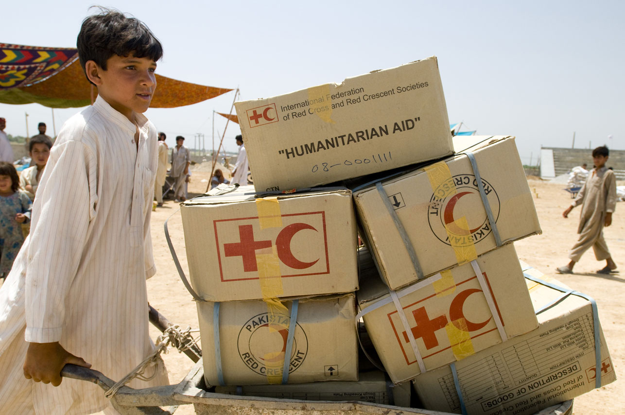 Pakistani refugee with boxes of supplies from the Pakistan Red Crescent at the Swabi IDP camp in Swabi, Pakistan on May 20, 2009.  There are now 1.5 million displaced people in Pakistan's North West.  
