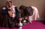 Afghan woman smoking a sheesha pipe at her home in Herat, Afghanistan on March 16, 2005. This tradition in Herat comes from neighboring Iran where the sheesha pipes are quiet common. However, it is rare in Afghanistan to see a woman ever smoking.