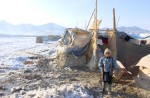 A young Afghan refugee at Chaman-e-Babrak refugee tent camp stands outside his home in the freezing cold.   Many refugees are homeless rural people who cannot be relocated to the countryside.  At least 18 have already dided this winter in Afghanistan. 