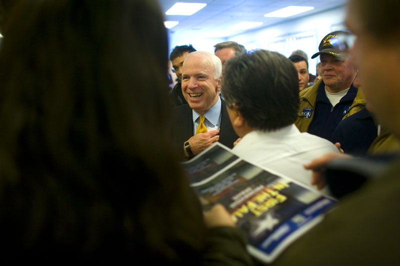 John McCain greets supporters after a town meeting as he campaigns for the Republican presidential nomination.