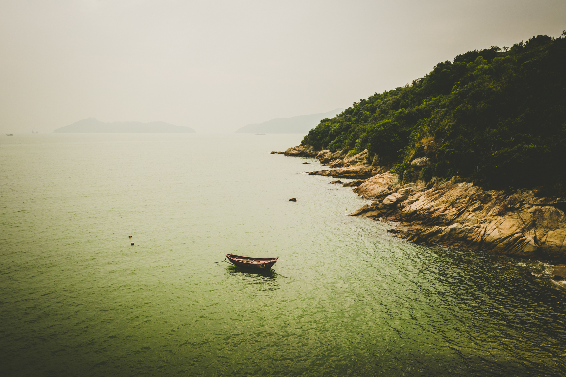 A lone rowboat tied to the shore on Lantau Island, Hong Kong.