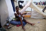 At Pone Rouge refugee camp, 23 year old Haitian quake survivor gives mother milk to her 7 month old baby Nadia next to her tent where she and 4 other family members live together. She lost her husband, brother, sister and other baby due to the January 12th earthquake.
