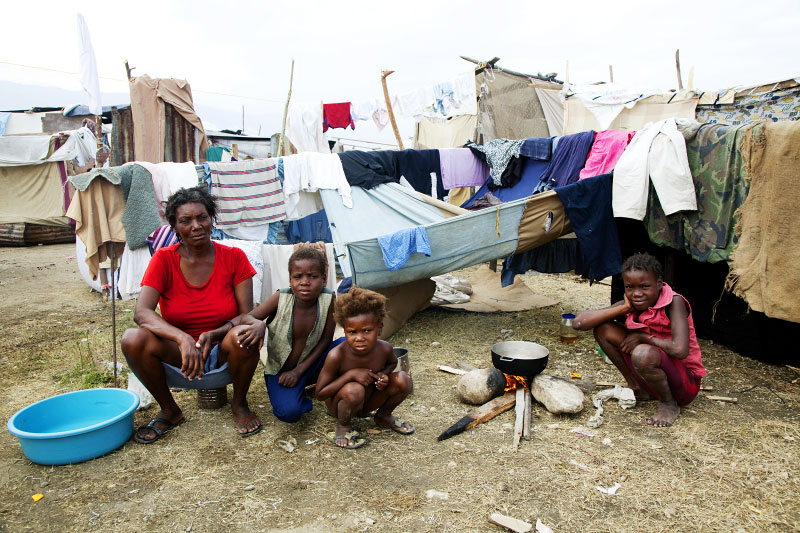 At Pont-Rouge refugee camp, Haitian earthquake IDP family, from the left, Vuergeme Fredric, 48, Jean Jacob, 8, Jean Rosena, 5, and Jean Lovelie, 9, stay at their tent where 9 family members live together. Vuergeme lost her mother, brother and two sons due to the January 12th quake.
