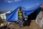 At Pont-Rouge refugee camp, 36 year old Haitian earthquake survivor Salomon Vilme and her 7 year old daughter Chrisla stay at their tent where 5 family members live together. 