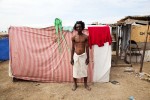 At Pone Rouge refugee camp, Apollon Ralpho, 30 year old Haitian quake survivor, stays in front of his shelter where he and 6 other family members live together. He lost his uncle due to the January 12th quake.